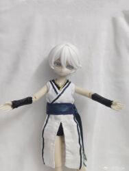 1girl absurdres bare_shoulders belt black_bracer black_shorts bracer chinese_clothes colored_eyelashes cowboy_shot doll doll_joints dress figure grey_eyes highres joints ling_yue_w outstretched_arms photo_(medium) realistic short_hair short_shorts shorts simple_background spread_arms tomboy vocaloid vsinger_(vocaloid) watermark weibo_username weibo_watermark white_dress white_eyelashes white_hair yanhe yanhe_(daojianchunqiu)