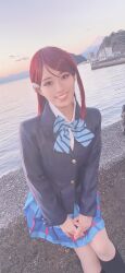 1girl beach cosplay cosplay_photo honamen_cos long_hair looking_at_viewer love_live! love_live!_sunshine!! outdoors photo_(medium) red_hair sakurauchi_riko school_uniform sitting sky smile water yellow_eyes