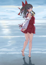 1girl bare_shoulders barefoot beach black_eyes black_hair bow commentary_request detached_sleeves expressionless full_body hair_bow hair_tubes hakurei_reimu hatakenaka_(kamagabuchi) highres long_hair looking_at_viewer looking_back red_bow red_skirt skirt soles solo toes touhou water