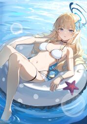 1girl alternate_costume barefoot bikini blonde_hair blue_archive blue_bow blue_eyes blue_halo bow breasts choker dampi day frilled_bikini frills hair_bow halo highres long_hair looking_at_viewer medium_breasts multi-strapped_bikini_bottom navel on_innertube open_mouth soaking_feet solo starfish swimsuit thigh_strap toki_(blue_archive) water wet white_bikini