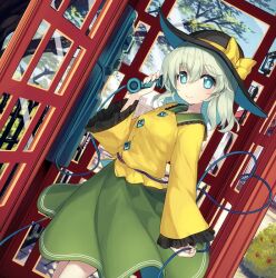 1girl black_hat bow bush buttons closed_mouth collared_shirt cowboy_shot day diamond_button dutch_angle fence frilled_shirt_collar frills green_eyes green_hair green_skirt hair_between_eyes hat hat_bow hat_ribbon heart heart_of_string holding holding_phone komeiji_koishi long_sleeves looking_at_viewer medium_hair minamura_haruki outdoors payphone phone phone_booth ribbon shirt skirt smile solo touhou tree wide_sleeves yellow_bow yellow_ribbon yellow_shirt
