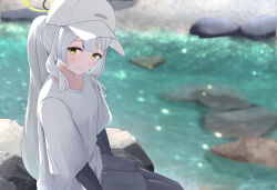 1girl absurdres baseball_cap black_pantyhose black_shirt black_shorts blue_archive blush commentary_request day feet_out_of_frame from_side ganba_artworks green_eyes green_halo hair_between_eyes halo hare_(blue_archive) hare_(camp)_(blue_archive) hat highres layered_sleeves long_hair long_sleeves looking_at_viewer outdoors pantyhose ponytail river rock shirt short_over_long_sleeves short_sleeves shorts sidelocks smile solo v-neck water white_hat white_shirt