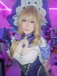 Rule 34 | 1girl, absurdres, arm tattoo, ass, blonde hair, breasts, cleavage, cosplay, hair ornament, hat, highres, jewelry, lisa (genshin impact), lisa (genshin impact) (cosplay), medium breasts, necklace, pantyhose, photo (medium), tattoo, thighs, witch, witch hat