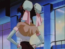 1990s_(style) 1girl animated animated_gif anime_screenshot bare_shoulders bouncing_breasts breasts brooch brown_hair burn-up burn-up_w center_opening cleavage dark-skinned_female dark_skin detached_collar detached_sleeves female_focus halterneck hands_on_own_hips jewelry large_breasts nanvel_candlestick no_bra outdoors retro_artstyle ribbon shorts solo talking upper_body