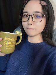 1girl absurdres black_hair blue_sweater brown_eyes cup forehead glasses_on_head gravure_idol highres indoors japanese_(nationality) looking_at_viewer medium_hair photo_(medium) selfie shinonome_umi sweater