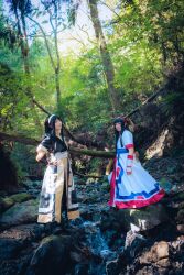 2girls ainu_clothes asian black_hair breasts cosplay fingerless_gloves gloves hair_ribbon hand_on_own_hip highres japanese_(nationality) legs long_hair looking_at_viewer multiple_girls nakoruru pants ribbon samurai_spirits small_breasts smile snk thighs weapon