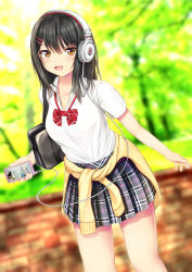 1girl black_hair blush breasts brick_wall cellphone clothes_around_waist collarbone female_focus headphones highres kurokami_(kurokaminohito) long_hair medium_breasts open_mouth original phone plaid_clothes plaid_skirt school_uniform shirt skirt smartphone smile solo sweater sweater_around_waist t-shirt thighs yellow_eyes