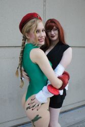 2girls ass blonde_hair blue_eyes braid braided_ponytail cammy_white cammy_white_(cosplay) cosplay crystal_graziano glasses grabbing_another&#039;s_ass groping highres hug leotard multiple_girls photo_(medium) red_hair smile street_fighter