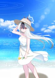 1girl absurdres beach black_hair black_horns blue_archive blue_sky blush breasts closed_mouth cloud commentary day demon_horns dress floating_hair flower halo hand_on_headwear hand_up hat highres holding holding_flower horns kayoko_(blue_archive) long_hair looking_at_viewer medium_breasts ocean outdoors red_eyes sky small_breasts smile solo standing sun_hat sundress user_fzxf7455 very_long_hair water white_dress white_hair