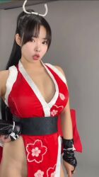 1girl animated bare_shoulders breasts cleavage cosplay crossed_arms fatal_fury hand_fan long_hair looking_at_viewer pelvic_curtain ponytail purin_cosplay real_life shiranui_mai shiranui_mai_(cosplay) sleeveless tagme the_king_of_fighters video