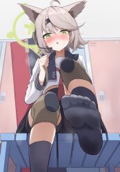 1girl absurdres ahoge animal_ears bike_shorts black_socks blue_archive blush brown_hair feet foot_focus fox_ears fox_girl green_eyes green_halo halo headset highres kirisame_oreo knee_pads locker locker_room neckerchief otogi_(blue_archive) red_neckerchief school_uniform serafuku skirt socks steam sweat towel weapon_case