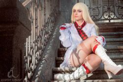 Rule 34 | 1girl, blonde hair, blue eyes, boots, breasts, cosplay, emilie de rochefort, emilie de rochefort (cosplay), fingerless gloves, gloves, jillstyler, long hair, long sleeves, medium breasts, real life, sitting, skirt, spanish (nationality), stairs, tekken, thighs