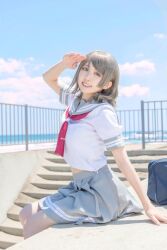 Rule 34 | 1girl, arm up, blue eyes, brown hair, cosplay, cosplay photo, grey hair, highres, love live!, love live! sunshine!!, midriff, photo (medium), real life, salute, school uniform, serafuku, short hair, sitting, skirt, smile, solo, stomach, uranohoshi school uniform, watanabe you
