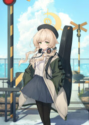 1girl absurdres alternate_costume alternate_hairstyle beret black_hat black_necktie black_pantyhose black_scrunchie blonde_hair blue_archive chain-link_fence character_name ciza_gomi closed_mouth cloud cloudy_sky commentary expressionless fence green_eyes green_jacket grey_skirt guitar_case hair_ornament hair_scrunchie halo hands_in_pockets hat headphones headphones_around_neck highres instrument_case jacket long_hair long_sleeves looking_at_viewer multicolored_jacket necktie ocean open_clothes open_jacket outdoors pantyhose professor_niyaniya_(blue_archive) railroad_crossing school_uniform scrunchie shirt skirt sky solo twintails two-tone_jacket white_jacket white_shirt yellow_halo