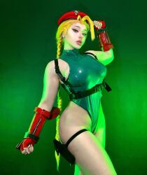 1girl beanie blonde_hair braid cammy_white cammy_white_(cosplay) cosplay curvy fingerless_gloves gloves green_leotard hana_cosplay hat highleg highleg_leotard highres italian_(nationality) leotard long_hair looking_at_viewer parted_lips photo_(medium) real_life revealing_clothes shiny_clothes shiny_skin solo street_fighter thong_leotard twin_braids wide_hips