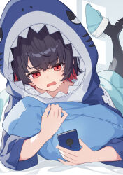 1girl absurdres animal_costume animal_hood black_hair blue_hoodie blush cellphone colored_inner_hair ellen_joe fins fish_tail highres holding holding_phone hood hoodie lying mole mole_under_eye multicolored_hair on_stomach phone red_eyes red_hair shark_costume shark_girl shark_hood shark_tail smartphone solo tail yuu_maraa zenless_zone_zero