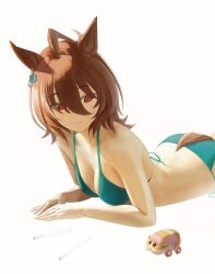 1girl agnes_tachyon_(umamusume) animal_ears bare_arms bare_shoulders bikini brown_eyes brown_hair closed_mouth green_bikini highres horse_ears horse_girl horse_tail looking_at_object looking_at_viewer lying o_ko_ge2024 on_stomach simple_background solo swimsuit tail toy umamusume white_background
