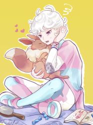 1boy 9no_kabe ahoge bede_(pokemon) blonde_hair book brush candy_wrapper commentary_request curly_hair dynamax_band eevee gen_1_pokemon hand_up heart highres holding holding_pokemon leggings lower_teeth_only male_focus nintendo open_mouth pantyhose pantyhose_under_shorts pink_shirt pokemon pokemon_(creature) pokemon_swsh shirt shoes short_hair shorts sitting squiggle sweatdrop teeth tongue undershirt yellow_background