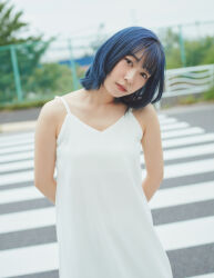 1girl arms_behind_back blue_hair blurry blurry_background brown_eyes dress flat_chest head_tilt japanese_(nationality) kobayashi_aika lipstick looking_at_viewer makeup outdoors photo_(medium) real_life short_hair standing voice_actor white_dress