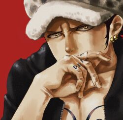 1boy black_coat black_hair chest_tattoo chiyo_(@ch_falgar) coat commentary earrings hand_tattoo hat highres jewelry looking_at_viewer male_focus one_piece red_background sideburns simple_background solo tattoo trafalgar_law upper_body yellow_eyes