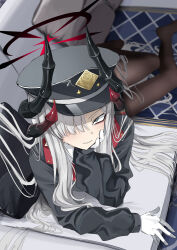 1girl absurdres black_jacket black_pantyhose blue_archive blue_eyes blush closed_mouth couch gloves grey_hair hair_over_one_eye hand_on_own_chin hat highres jacket long_hair looking_at_viewer lying makoto_(blue_archive) no_shoes noripote_(noripote831) on_couch on_side pantyhose peaked_cap sidelocks smile solo white_gloves