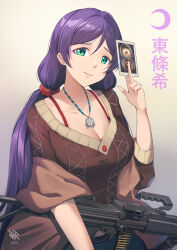 1girl 2025 ammunition artist_logo breasts brown_background brown_shawl brown_shirt card character_name collarbone crescent green_eyes gun highres hiroki_ree holding holding_card imi_negev jewelry large_breasts light_machine_gun logo long_hair looking_at_viewer love_live! love_live!_school_idol_project low_twintails machine_gun necklace purple_hair shawl shirt smile solo tojo_nozomi twintails weapon