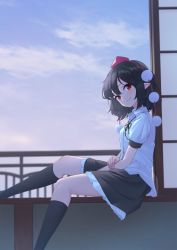 1girl between_legs black_hair black_ribbon black_skirt black_socks blue_sky cloud collared_shirt commentary_request evening feet_out_of_frame frilled_skirt frills hair_between_eyes hand_on_own_arm hat head_tilt highres indoors kanpa_(campagne_9) kneehighs looking_at_viewer looking_to_the_side no_wings pointy_ears pom_pom_(clothes) railing red_eyes ribbon shameimaru_aya shirt short_hair shouji sitting sitting_in_window skirt sky sliding_doors socks solo sunset tokin_hat touhou veranda white_shirt wing_collar