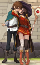 1boy 1girl bandaged_leg bandages belt blush boots cape closed_eyes couple green_eyes hat highres kiss kono_subarashii_sekai_ni_shukufuku_wo! megumin pointing satou_kazuma staff tongue tongue_out witch_hat