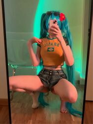 Rule 34 | 1girl, brazilian miku, cellphone, cosplay, foggycat, full body, hair ornament, hatsune miku, highres, jeans shorts, legs, legs apart, long hair, mirror, panties, phone, photo (medium), presenting, real life, selfie, sexually suggestive, shorts, solo, squatting, underwear, very long hair