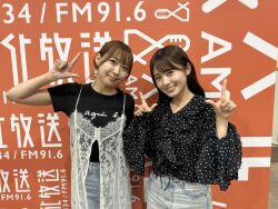 2girls aida_rikako black_shirt denim indoors japanese_(nationality) jeans looking_at_viewer multiple_girls pants photo_(medium) real_life saito_shuka shirt smile standing voice_actor