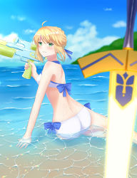 1girl absurdres ahoge arm_support artoria_pendragon_(fate) artoria_pendragon_(swimsuit_archer)_(fate) artoria_pendragon_(swimsuit_archer)_(first_ascension)_(fate) ass beach bikini blonde_hair blue_ribbon blue_sky blurry cloud day depth_of_field excalibur_(fate/stay_night) fate/grand_order fate_(series) green_eyes highres horizon ocean partially_submerged ribbon sand side-tie_bikini_bottom sii_artatm sky solo swimsuit water water_gun waves white_bikini