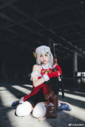 1girl absurdres bare_shoulders bow christmas cosplay_photo dress girls&#039;_frontline gloves gun hat highres holding holding_gun holding_weapon long_hair looking_at_viewer photo_(medium) red_dress red_gloves santa_hat socks solo svd_(girls&#039;_frontline) tagme weapon white_socks