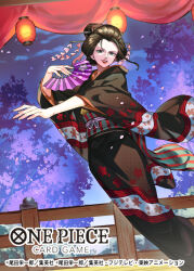 Rule 34 | 1girl, black hair, cherry blossoms, commentary request, copyright name, falling petals, feet out of frame, floral print, floral print kimono, geisha, hair ornament, hand fan, highres, holding, holding fan, kanzashi, lantern, looking to the side, nico robin, nico robin (wano), night, obi, official art, one piece, one piece card game, outstretched arm, paper lantern, petals, pink petals, print kimono, red lips, sash, sidelocks, smile, solo, sunohara (encount), wide sleeves