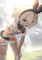 1girl bea_(pokemon) bent_over black_bodysuit black_hairband blonde_hair bodysuit bodysuit_under_clothes bow_hairband collared_shirt commentary day dynamax_band eyelashes gloves grey_eyes hairband hand_on_own_knee hand_up highres knee_pads nintendo open_mouth outdoors pokemon pokemon_swsh print_shirt print_shorts shirt short_hair short_sleeves shorts single_glove solo watermark white_shirt zeroartwo