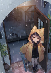 1girl :o animal_ear_hood black_boots black_shirt black_slippers blue_umbrella blush boots brown_eyes brown_hair commentary_request door fake_animal_ears full_body highres holding holding_umbrella hood hood_up long_hair long_sleeves looking_at_viewer open_mouth original outdoors rain raincoat shirt shorts slippers solo standing tokuno_yuika umbrella unworn_slippers white_shorts yellow_raincoat