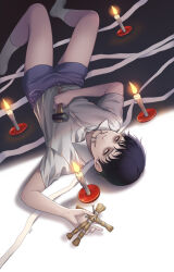 1boy artist_name bishounen black_hair candle child hammer highres holding holding_hammer itou_junji_kyoufu junji_ito_collection looking_at_viewer lying male_focus nail_(hardware) on_back save_(naita_aooni) shirt short_hair shorts smile socks solo straw_doll teeth thighs tsujii_souichi upside-down white_shirt white_socks