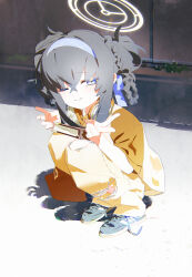 1girl absurdres alternate_costume alternate_hairstyle bags_under_eyes bent_v black_hair black_shoes blue_archive blue_eyes blue_hairband blush bm_tol book closed_mouth double_v full_body hair_between_eyes hairband halo headphones headphones_around_neck highres long_hair looking_at_viewer one_eye_closed outdoors pants shirt shoes short_sleeves smile sneakers solo squatting torn_clothes torn_pants ui_(blue_archive) v yellow_pants
