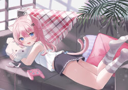 1girl :d animal_ears black_shorts blue_eyes camisole cat_ears cat_girl cat_tail cellphone controller couch fang game_controller gamepad highres hugging_object long_hair looking_at_viewer loungewear lying meibi_1 on_couch on_stomach open_mouth original phone pillow pillow_hug pink_hair plant short_shorts shorts skin_fang smartphone smile tail tail_wagging twitter_username white_camisole