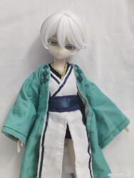 1girl absurdres belt black_belt character_doll chinese_clothes colored_eyelashes doll dress figure flat_chest grey_eyes highres light_smile ling_yue_w long_sleeves photo_(medium) realistic short_hair simple_background tomboy vocaloid vsinger_(vocaloid) white_dress white_eyelashes white_hair wide_sleeves yanhe yanhe_(daojianchunqiu)