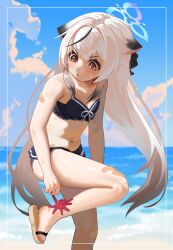 1girl absurdres animal_ears bandaid bandaid_on_arm bandaid_on_knee bandaid_on_leg beach belly bikini black_bikini blue_archive ch1ckpyo day feet highres kokona_(blue_archive) loli long_hair octopus outdoors sandals swimsuit toes white_hair