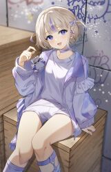 1girl :d banpen_(todoroki_hajime) blonde_hair center-flap_bangs choker commentary_request feet_out_of_frame frilled_jacket frills graffiti hair_ornament hairclip hand_up highres holding hololive hololive_dev_is iridescent jacket knees_together_feet_apart leg_warmers legwear_garter looking_at_viewer multicolored_hair open_clothes open_jacket open_mouth purple_choker purple_eyes purple_hair shirt shirt_tucked_in short_hair shorts sitting smile solo streaked_hair todoroki_hajime todoroki_hajime_(1st_costume) two_side_up virtual_youtuber white_jacket white_leg_warmers white_shirt white_shorts yoshidadon