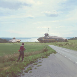 1boy abandoned brown_hair cloud cloudy_sky day from_behind grass highres jacket long_sleeves outdoors pants road scenery science_fiction short_hair simon_stalenhag sky solo standing swedish_machines
