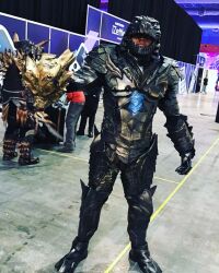 Rule 34 | 1boy, adapted costume, armor, batzemo, blue eyes, convention, cosplay, cosplay photo, disembodied head, glowing, glowing eyes, godzilla, godzilla: king of the monsters, godzilla (cosplay), godzilla (monsterverse) (cosplay), godzilla (series), highres, kaiju, king ghidorah, legendary pictures, monsterverse, multiple others, no pupils, personification, photo (medium), real life, salvador hernandez, toho