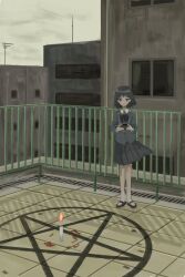 1girl black_bow black_bowtie black_hair black_shoes bow bowtie building camera candle expressionless highres holding holding_camera looking_at_viewer magic_circle original outdoors overcast pentagram pleated_skirt railing rooftop shoes skirt sky socks solo yossy_nekochan