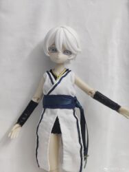 1girl absurdres bare_shoulders belt black_bracer black_shorts bracer chinese_clothes colored_eyelashes doll doll_joints dress figure grey_eyes highres joints ling_yue_w photo_(medium) realistic short_hair short_shorts shorts simple_background tomboy vocaloid vsinger_(vocaloid) watermark weibo_username weibo_watermark white_dress white_eyelashes white_hair yanhe yanhe_(daojianchunqiu)