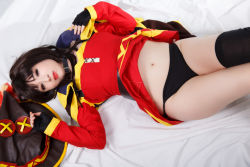Rule 34 | 1girl, absurdres, belt, belt collar, black hair, black panties, choker, collar, cosplay, dress, fingerless gloves, gloves, hat, highres, kitty-honey, kono subarashii sekai ni shukufuku wo!, looking at viewer, lying, megumin, megumin (cosplay), navel, on back, panties, photo (medium), red eyes, single thighhigh, thighhighs, underwear, witch hat