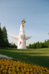 absurdres flower grass highres japan okamoto_tarou outdoors park photo_(medium) sculpture tower_of_the_sun tree