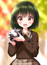 Rule 34 | 1girl, blurry, blurry background, blush, camera, dot nose, facing viewer, feet out of frame, female focus, green eyes, hair between eyes, highres, holding, holding camera, kin-iro mosaic, long hair, long sleeves, oomiya shinobu, open mouth, outdoors, ruu (tksymkw), shirt, short hair, skirt, solo, standing