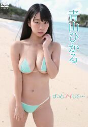 1girl aoyama_hikaru beach bikini black_hair blurry blurry_background breasts cleavage collarbone cover dvd_cover green_bikini highres japanese_(nationality) japanese_text large_breasts long_hair looking_at_viewer navel outdoors photo_(medium) real_life sand sideboob standing swimsuit underboob water