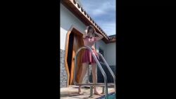1girl absurdres air_bubble animated black_hair blowing_bubbles bubble chinese_commentary clothes_lift highres partially_submerged pool real_life shirt skirt skirt_lift sound submerged tagme underwater video water